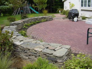 Brick patio with stone retaining walls in Concord NH