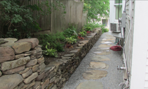 Natural stone retaining wall with step stone path in Concord New Hampshire