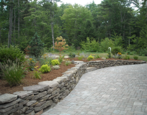 Stone retaining walls with paver patio in Canterbury NH