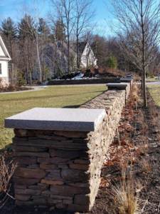 Freestanding Wall with Granite Caps by New Hampshire landscaper Dave DeJohn