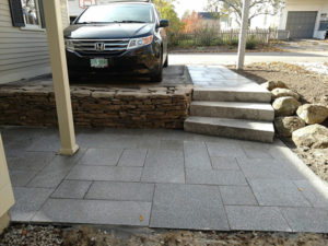 DeJohn Landscaping installs a pattern granite pavers and retaining wall