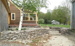 Natural stone entry wall on a NH farm property by DeJohn Landscaping